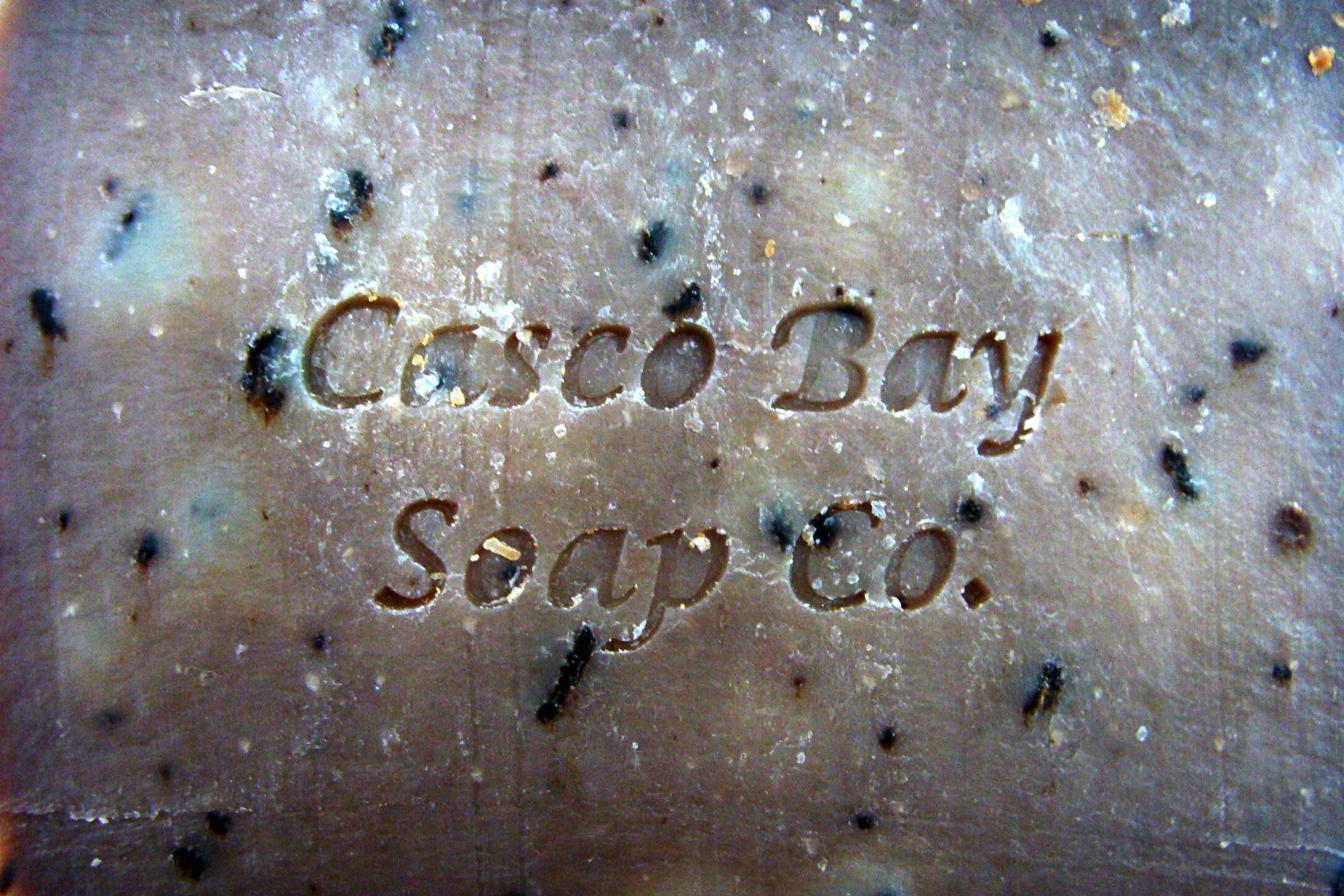 a close up of a brown bar of soap with flecks of brown
