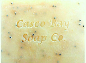 a close up of a yellow bar of soap with black flecks