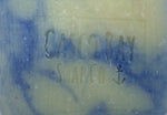 close up of a creamy white bar of soap with blue swirls