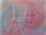 close up of creamy white soap bar with red and blue swirls