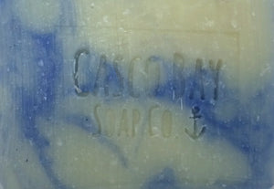 close up of creamy white soap bar with blue swirls