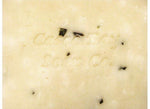 close up of an off white bar of soap with green flecks