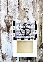 a white box with a cutout shows a creamy white bar of soap
